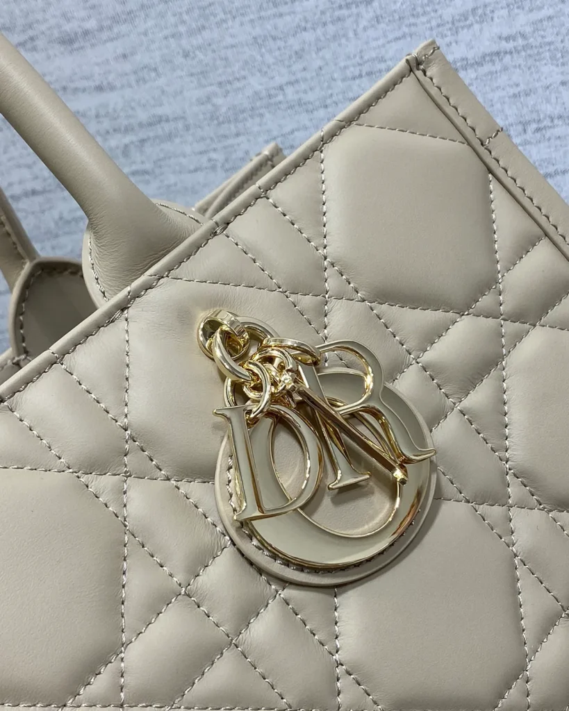 Taupe Geometric Quilted Tote — charm detail view