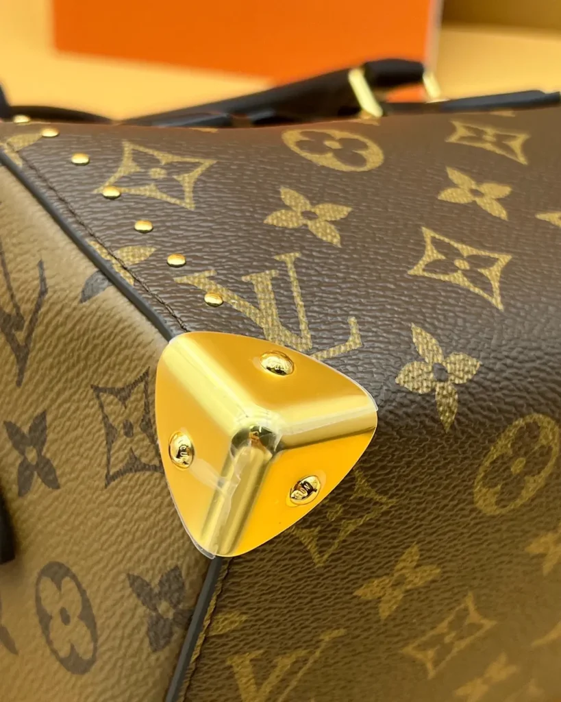 Brown Monogram Studded Trunk Bag — corner detail view
