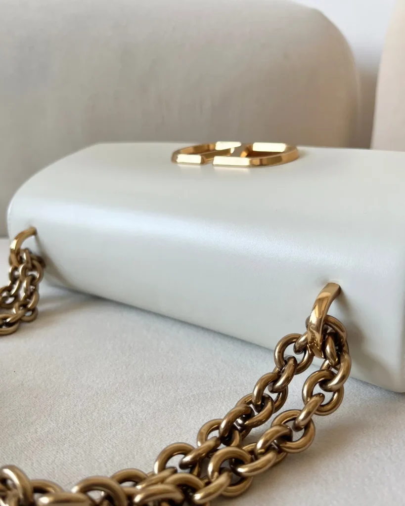 Ivory Curved-Flap Chain Shoulder Bag — closure detail view
