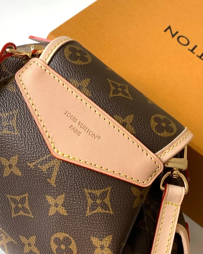 Brown Monogram Buckled Flap Satchel — strap tab view