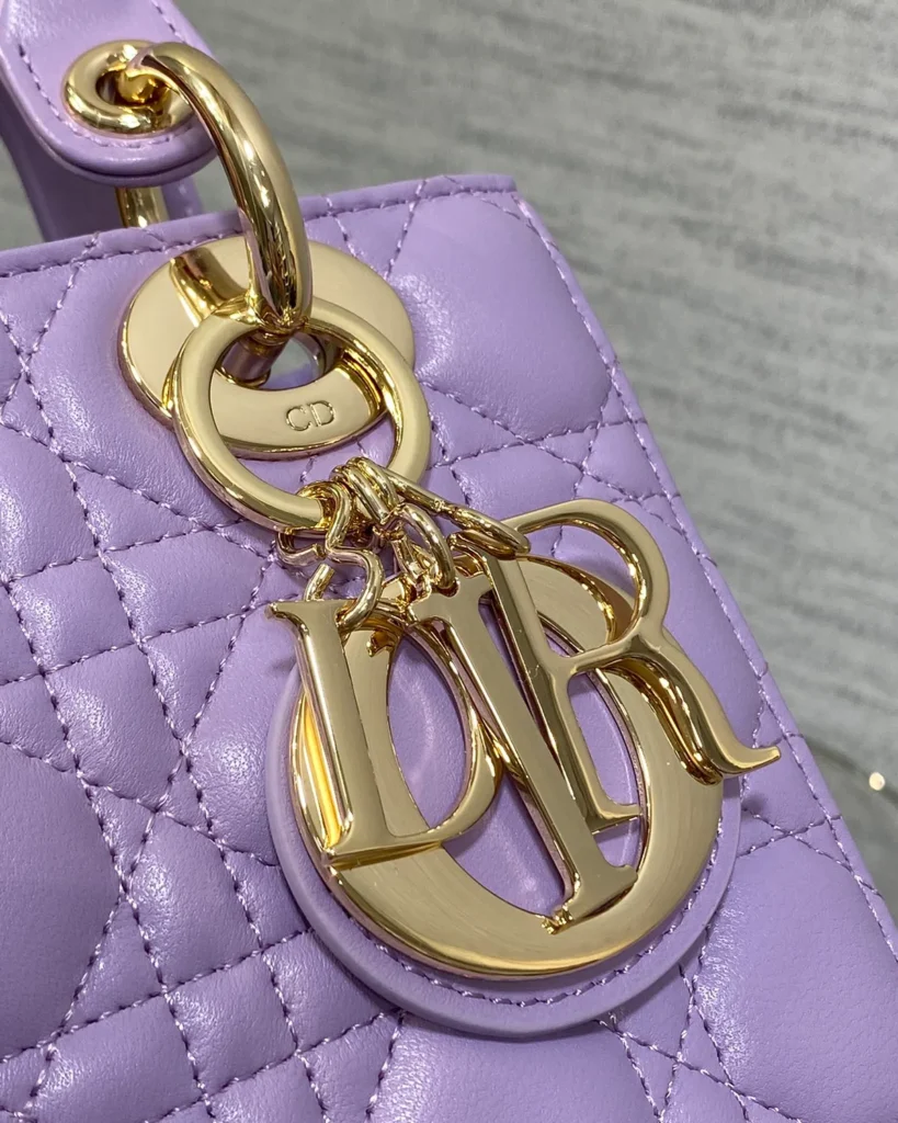 Lilac Quilted Top Handle Bag — charm detail view