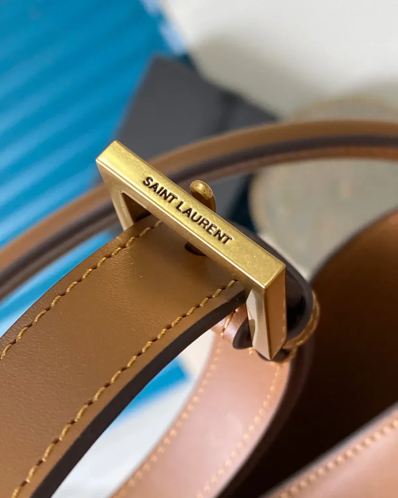 Tan Curved-Top Bucket Bag — buckle detail view
