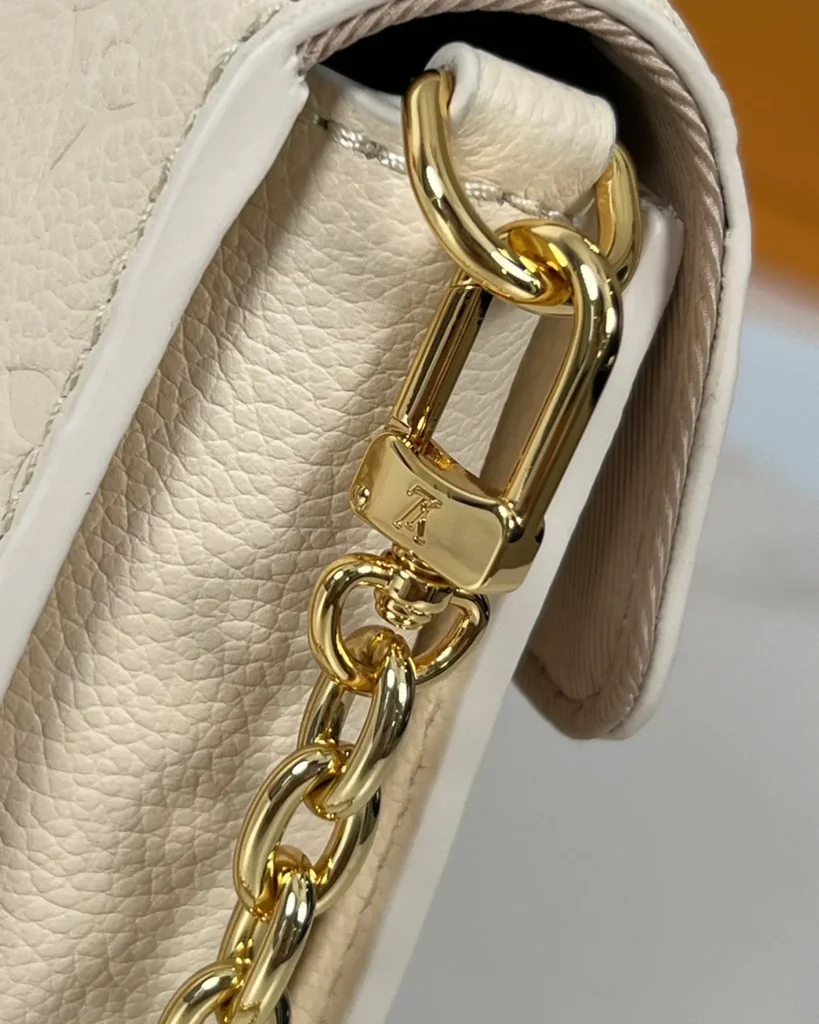 Cream Embossed Flap Chain Wallet — chain clip view