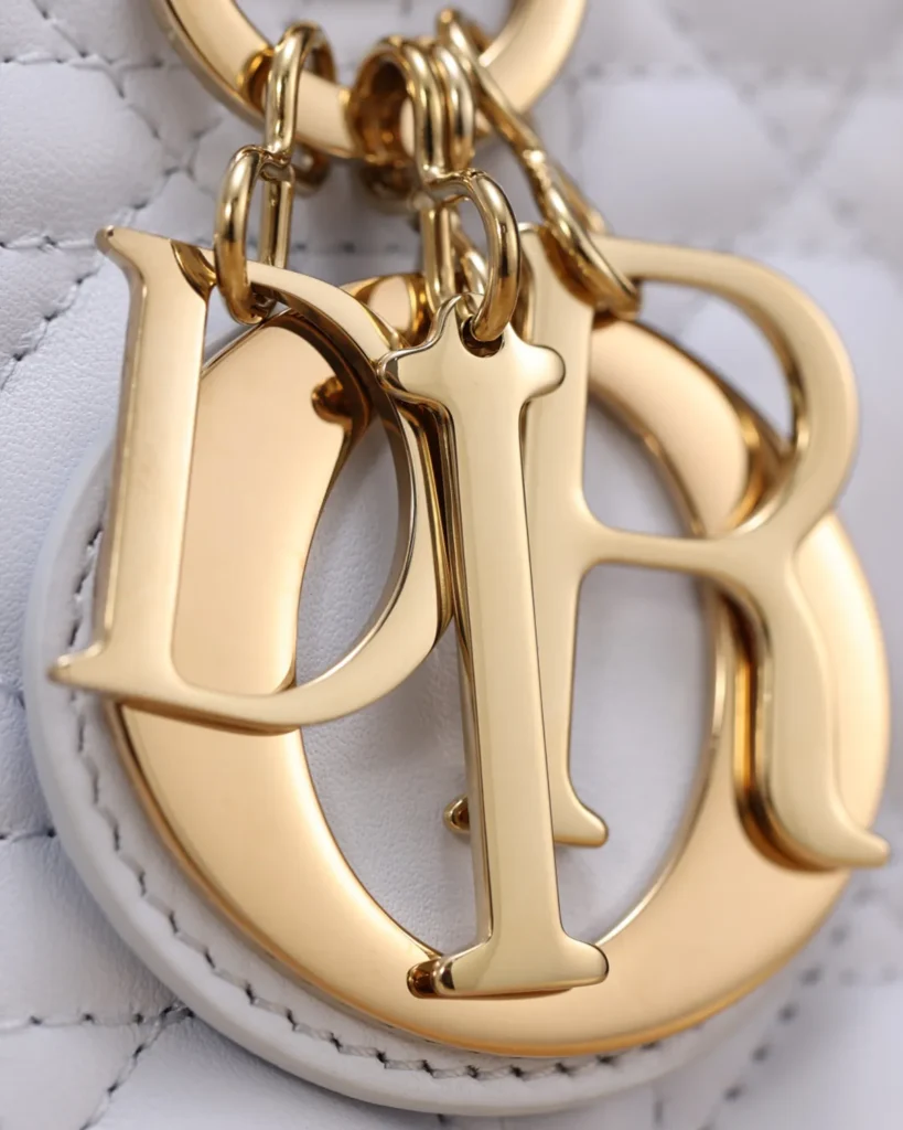 Pale Gray Quilted Top Handle Bag — charms detail view