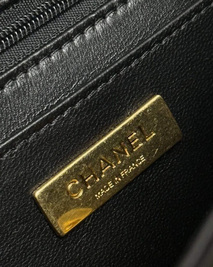 Glossy Black Quilted Handle Clutch — interior detail view