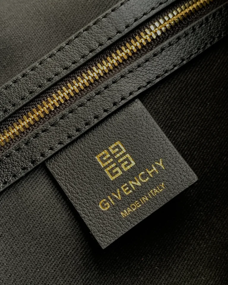 Black Curved-Top Buckle Shoulder Bag — label detail