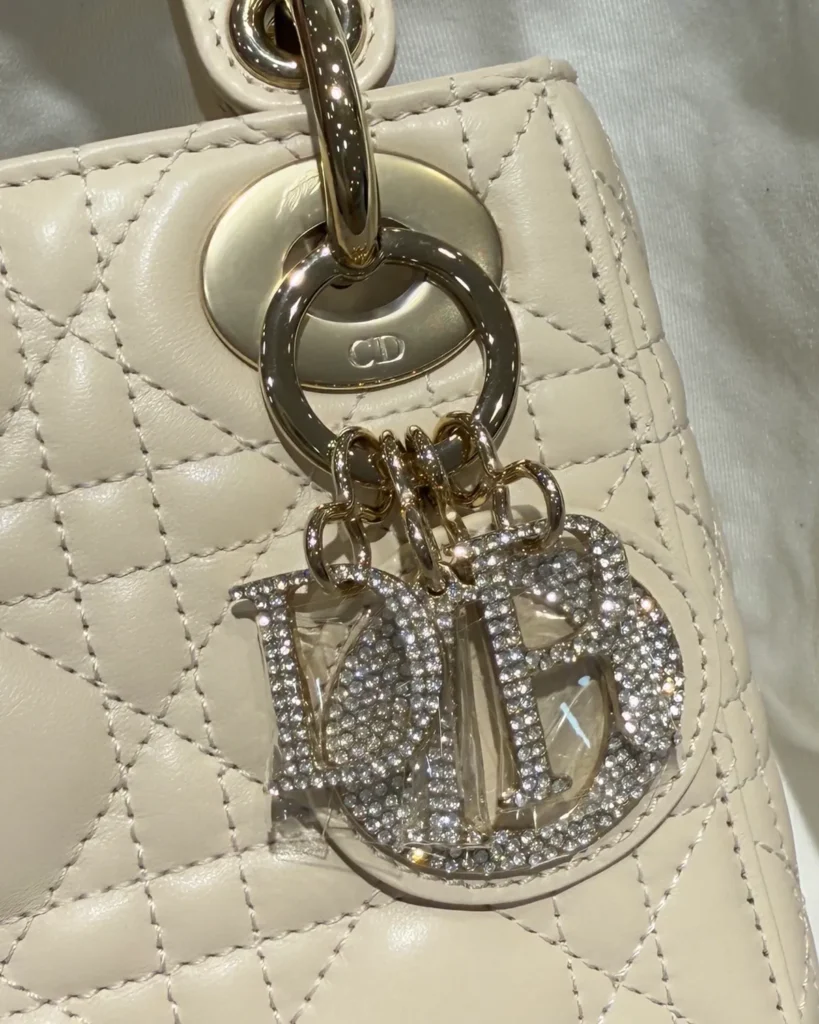 Cream Quilted Top Handle Bag with Sparkling Charms — charms view