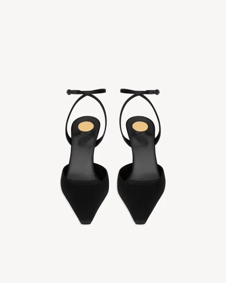Top view of black pointed-toe slingback pumps with buckled ankle straps