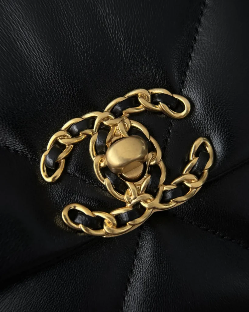 Black Quilted Mixed-Chain Flap Bag — clasp closeup view