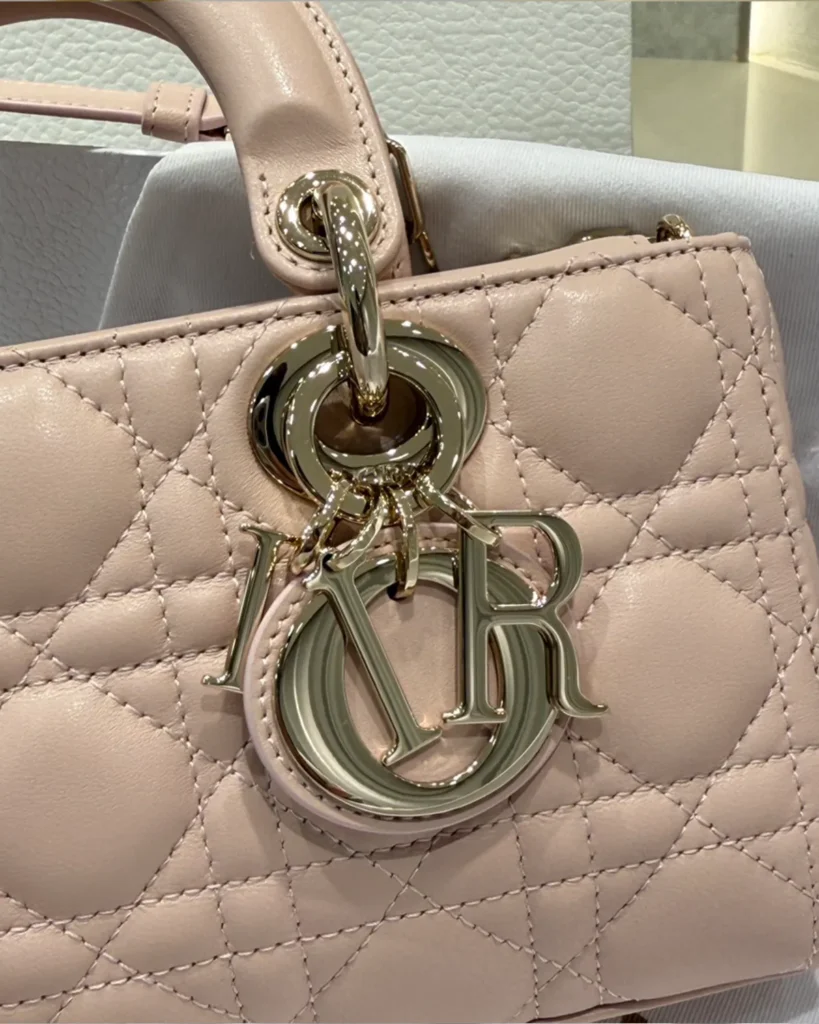 Powder Pink Quilted East West Handbag — charm detail view
