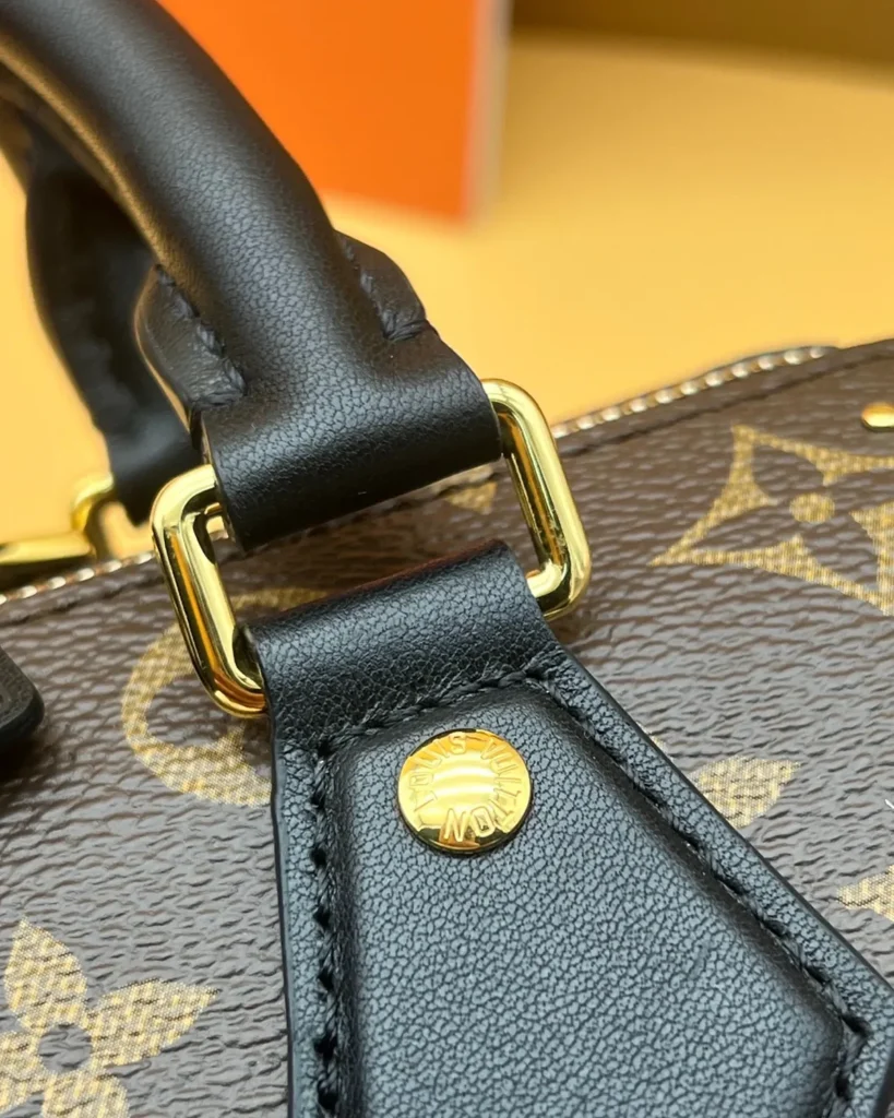 Brown Monogram Studded Trunk Bag — handle tab view