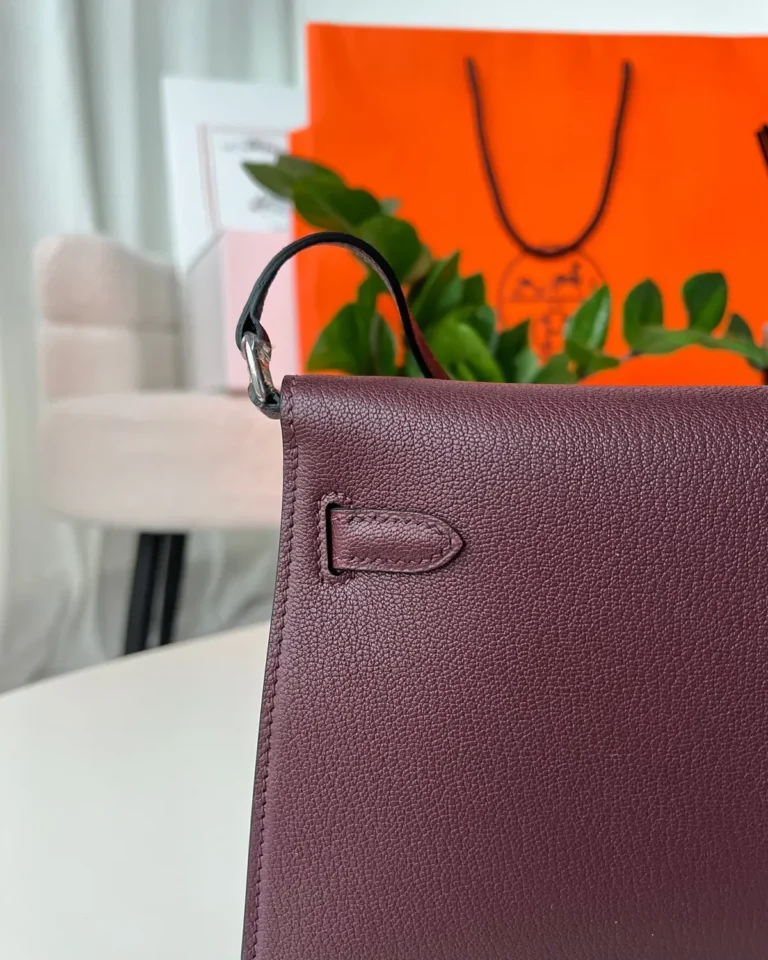 Burgundy structured shoulder bag, back stitching view