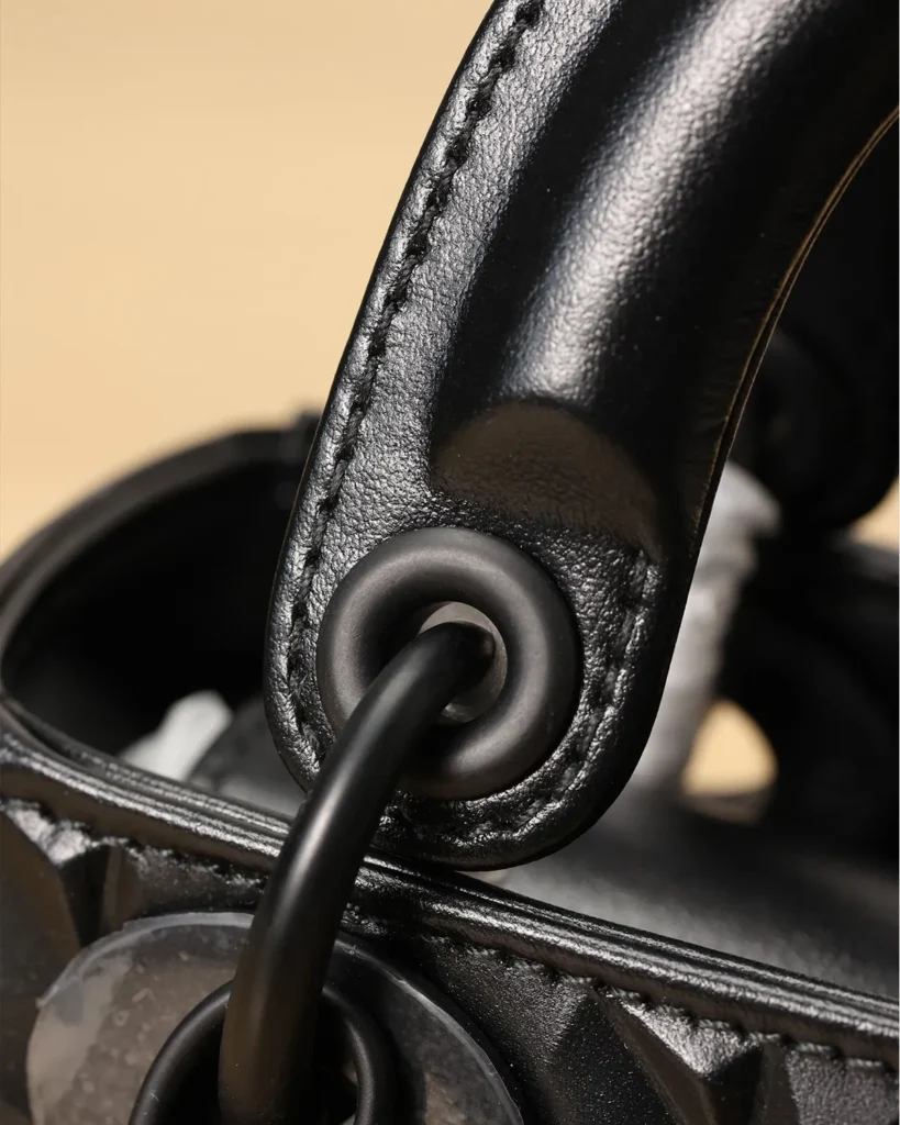 Black Faceted Top Handle Bag — handle detail view