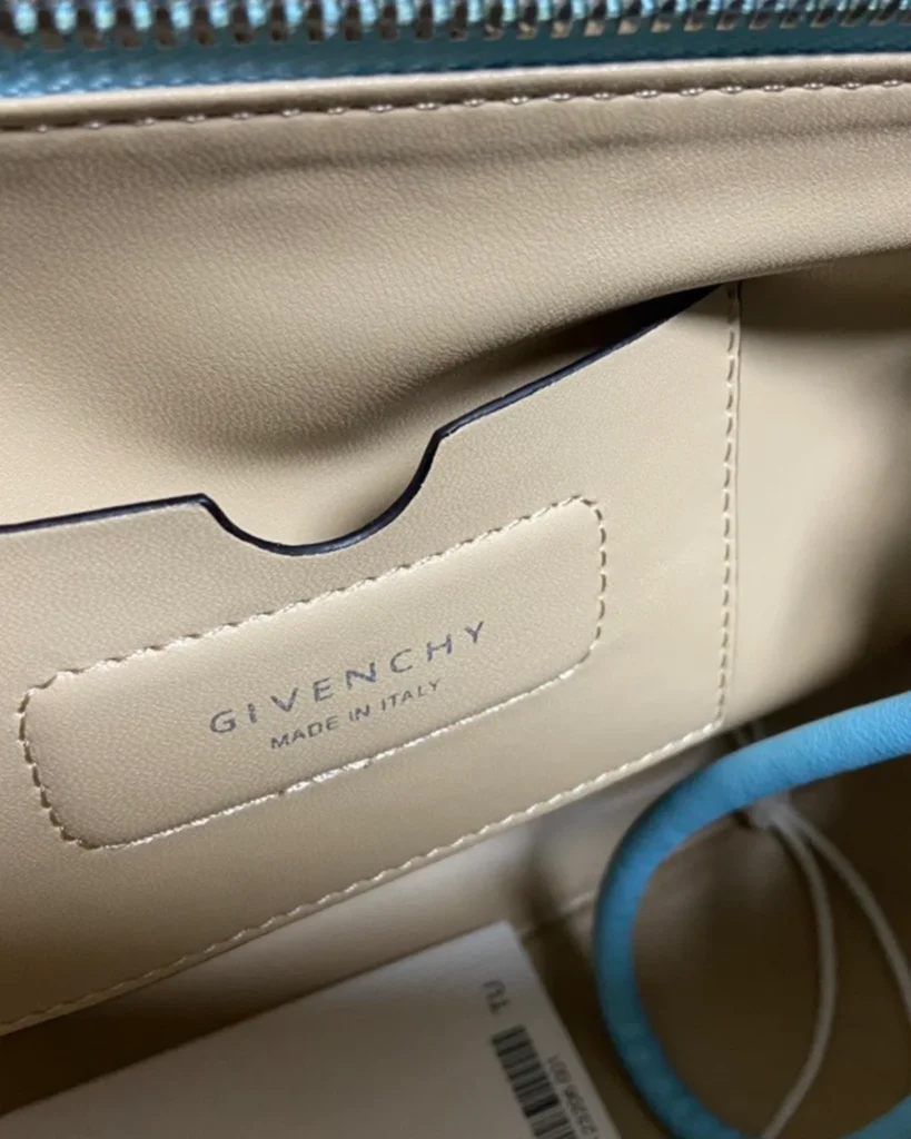 Blue Braided-Handle Flap Bag — label detail