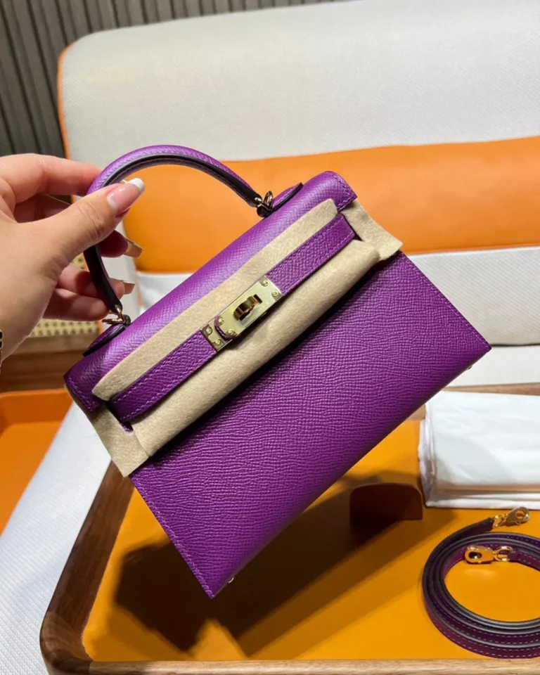 Kelly-Inspired Mini Anemone Purple Top-Handle Bag, angled front held by top handle