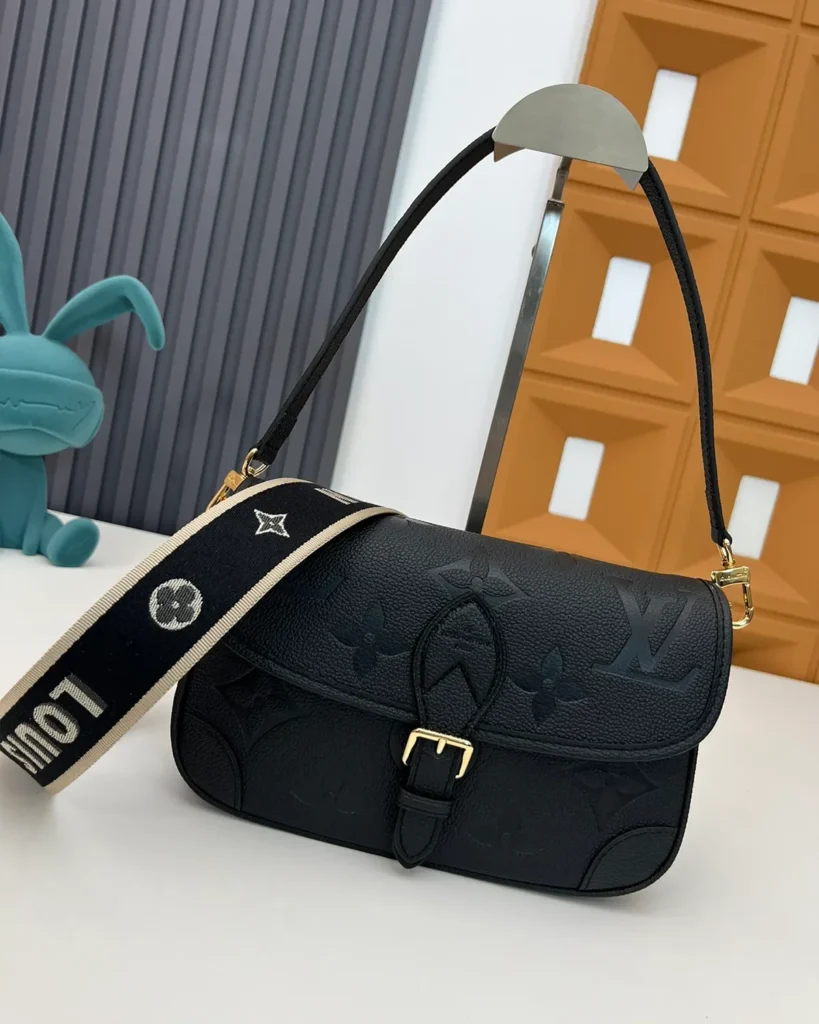 Black Embossed-Monogram Buckle Satchel — three quarter view