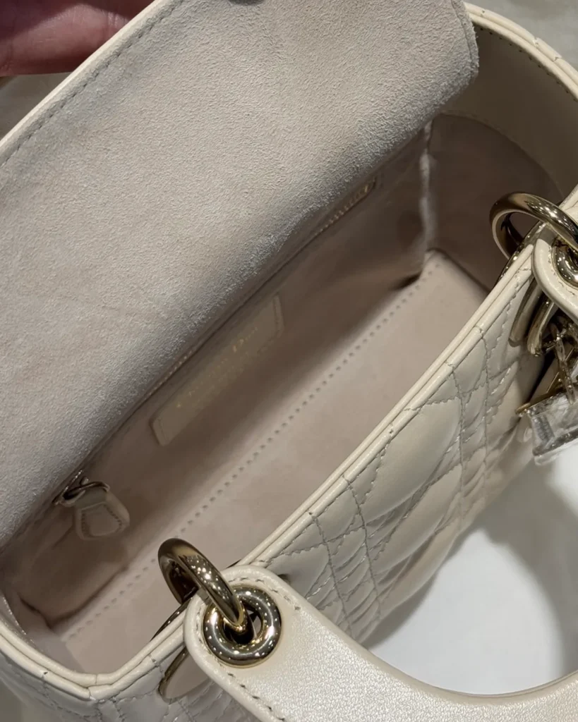 Cream Quilted Top Handle Bag with Sparkling Charms — interior view
