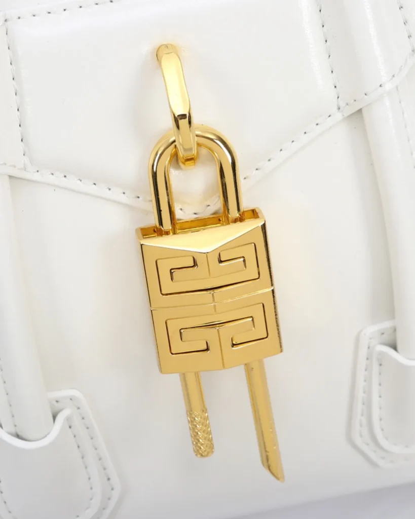 White Lock Detail Top Handle Bag — lock detail view