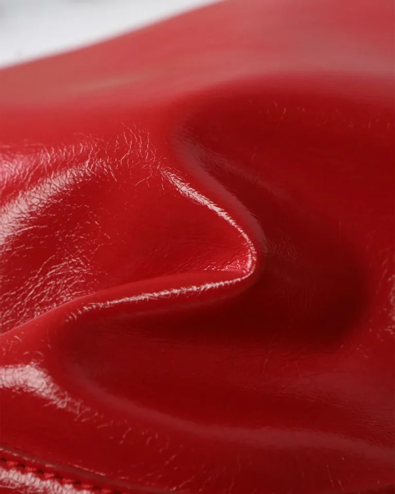 Glossy Red Buckle Shoulder Bag — texture detail