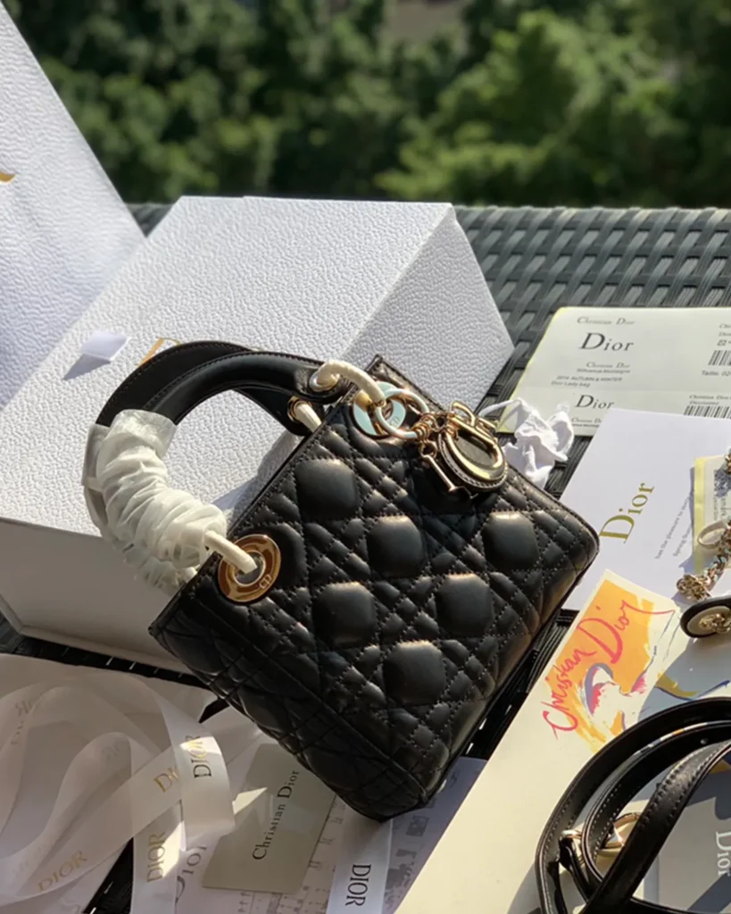 Black Quilted Compact Top Handle Bag — front view