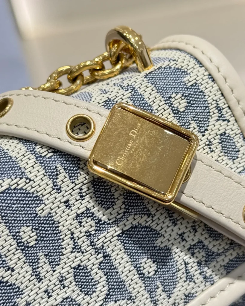Blue and Cream Patterned Flap Bag — strap buckle view
