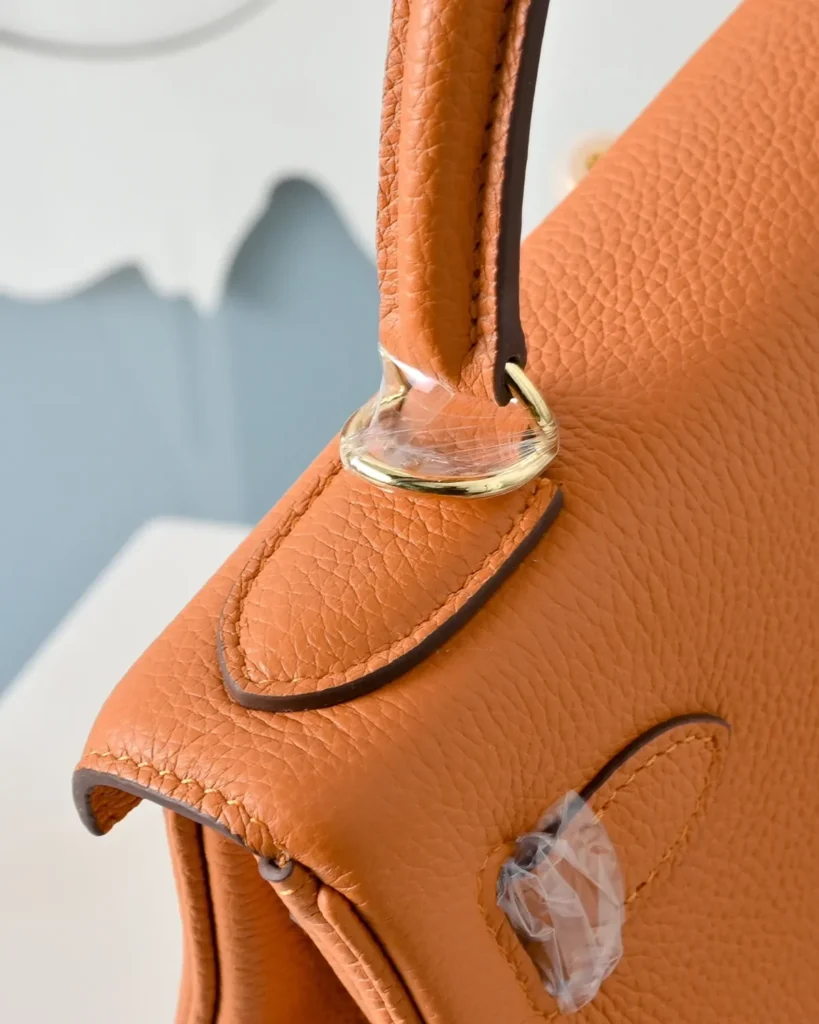 Kelly-Inspired 28 Orange Structured Top-Handle Bag, handle attachment close-up