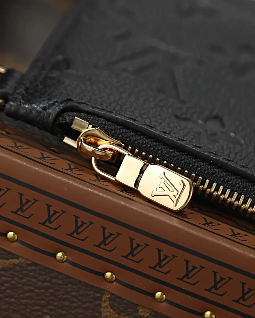 Black Embossed Monogram Bucket Bag — zipper view