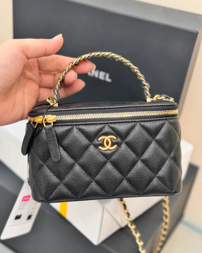 Black Quilted Chain-Handle Vanity Bag — held front view