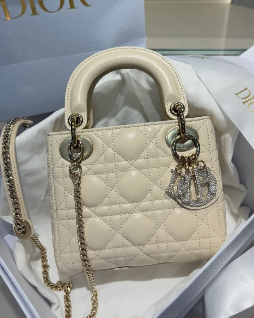 Cream Quilted Top Handle Bag with Sparkling Charms — front view