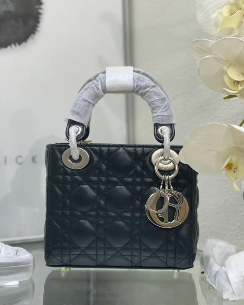 Black Quilted Top Handle Bag with Silver-Tone Charms — front view