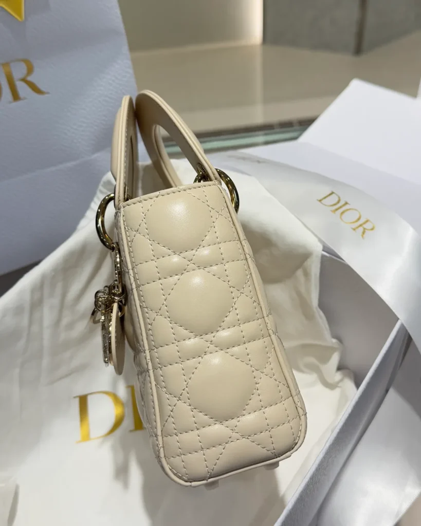 Cream Quilted Top Handle Bag with Sparkling Charms — side view