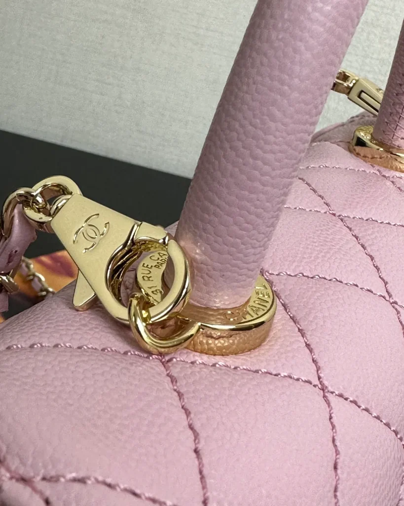 Light Pink Quilted Top-Handle Flap Bag — handle detail view