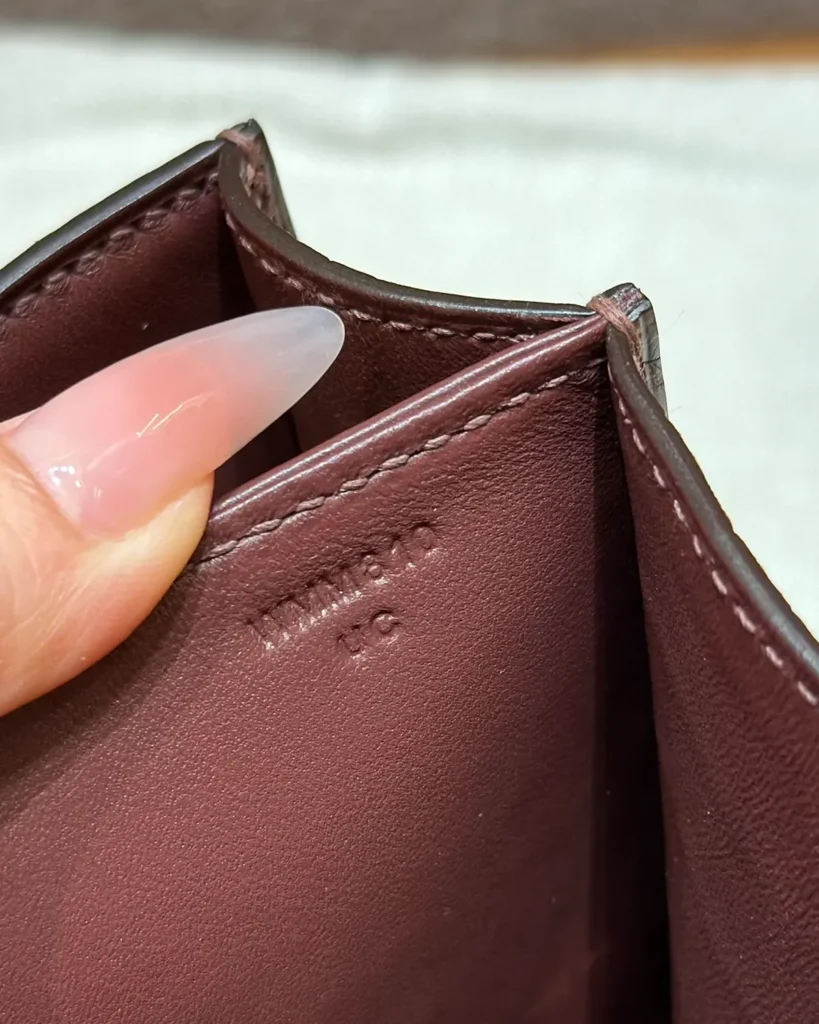 Close-up of stitched interior divider and upper edge of the brown mini bag