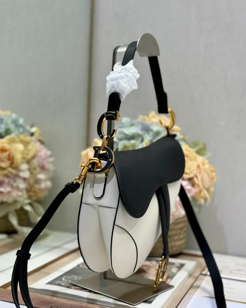 Cream and Black Asymmetric Saddle Bag — side view