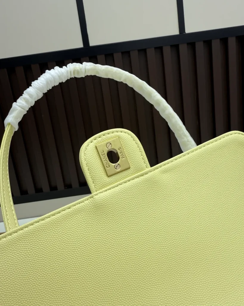 Pale Yellow Long-Handle Flap Bag — lock detail view