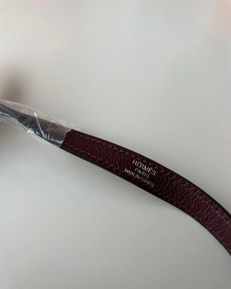 Burgundy structured shoulder bag, strap detail view