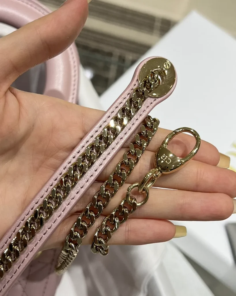 Pearlescent Pink Quilted Top Handle Bag — chain strap view