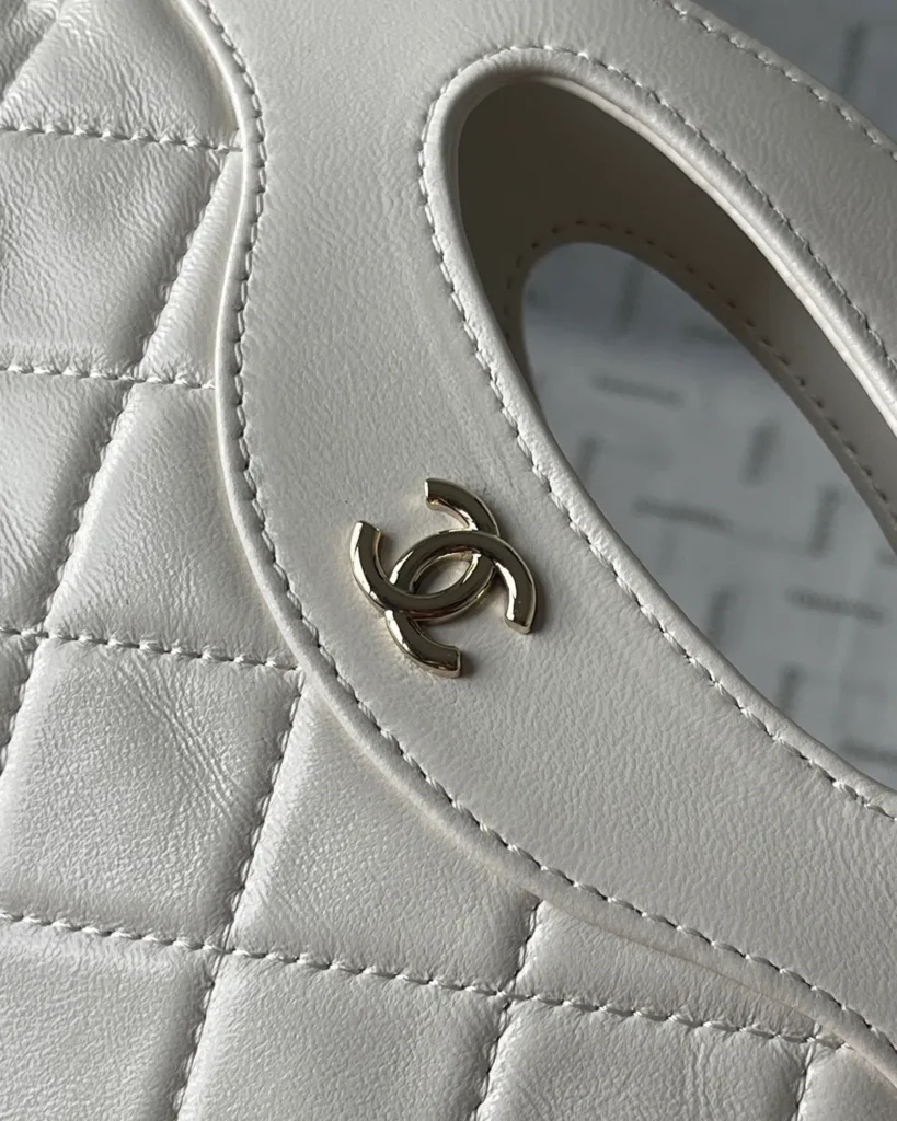 Ivory Quilted Cutout-Handle Tote — handle detail view