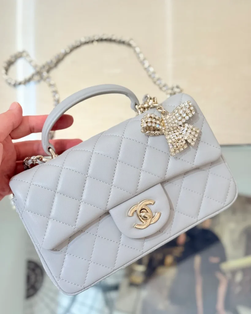 Pale Grey Quilted Top-Handle Flap Bag — top handle view
