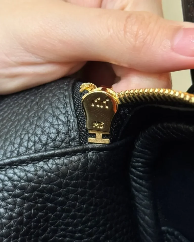 Black Folded Shoulder Bag with Gold-Tone Details — zip detail view