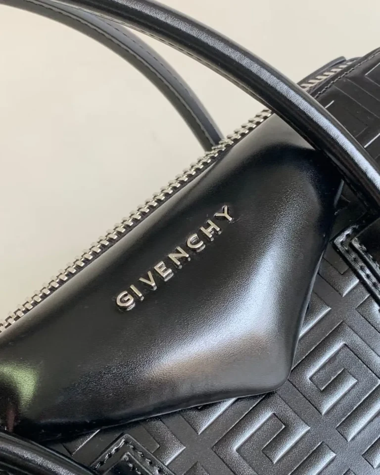 Black Geometric Embossed Twin-Handle Satchel — logo detail