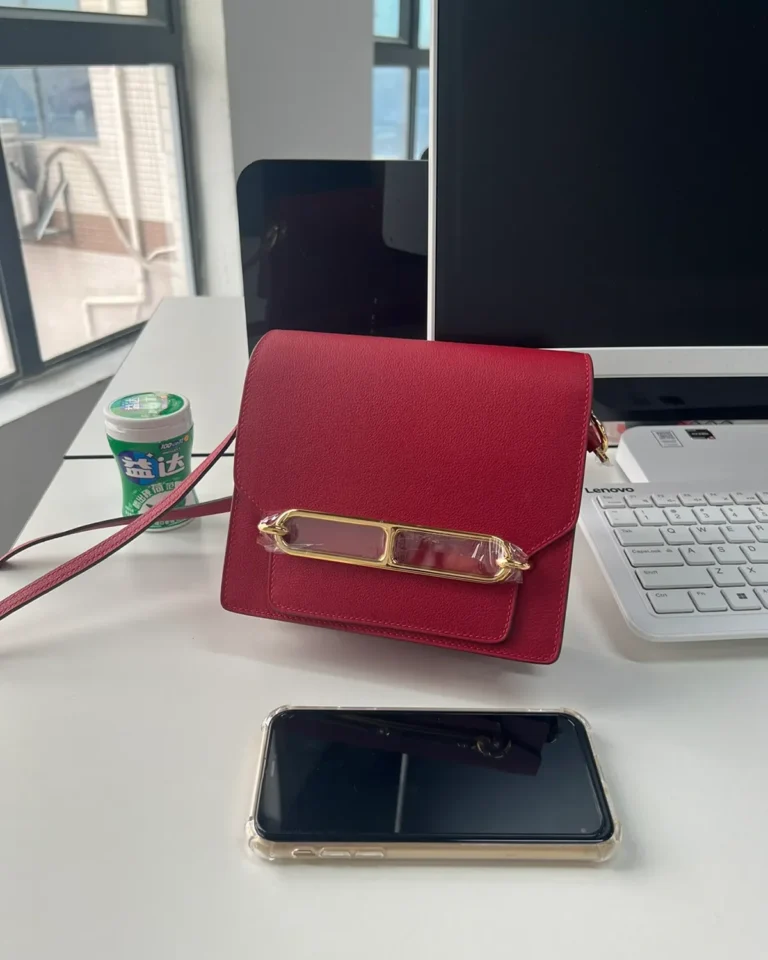 Red roulis-inspired mini bag, front size comparison view