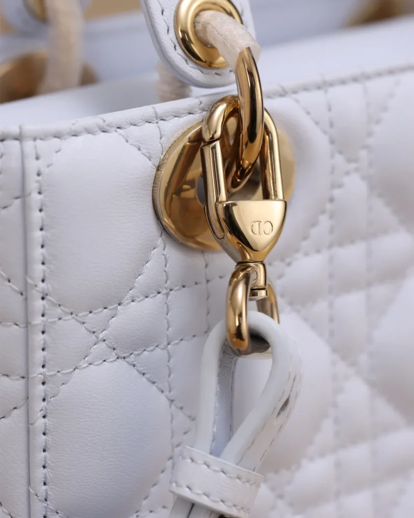 Pale Gray Quilted Top Handle Bag — strap clasp view