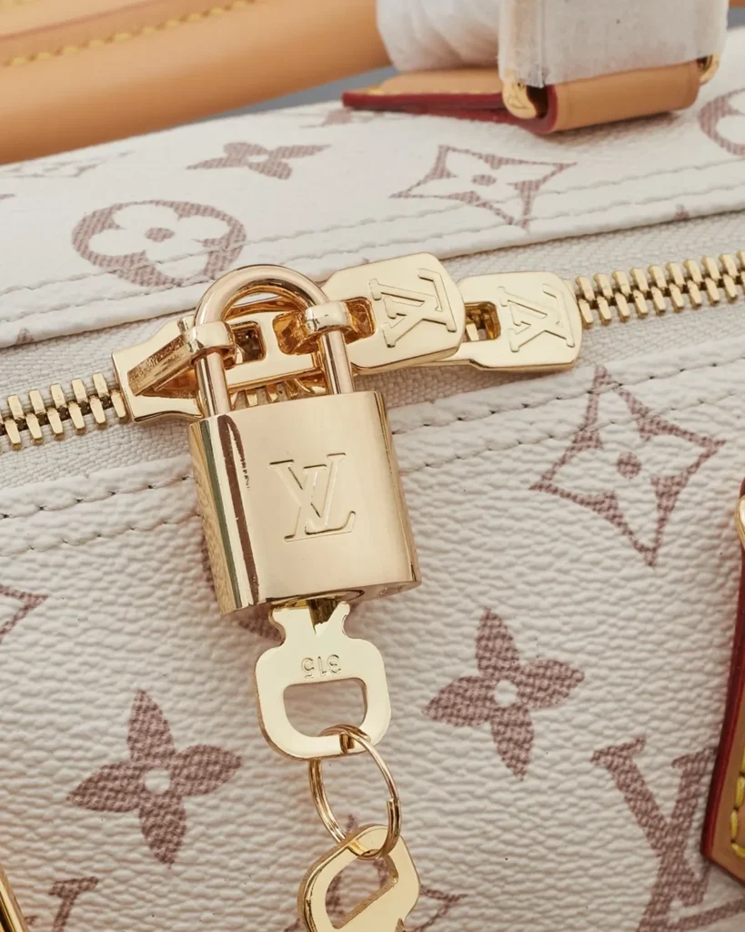 Cream Monogram Top-Handle Bag with Colorful Charms — padlock view